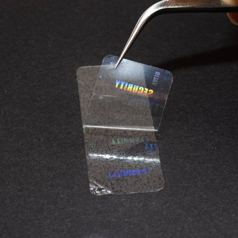 Transparent sealing film with a hidden hologram labels 45x17 mm