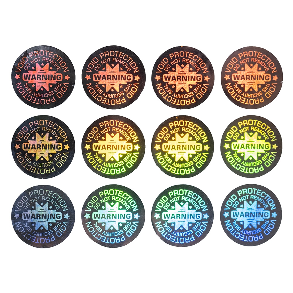 Circular silver holographic seal with a “warning” and a diameter of 11 mm