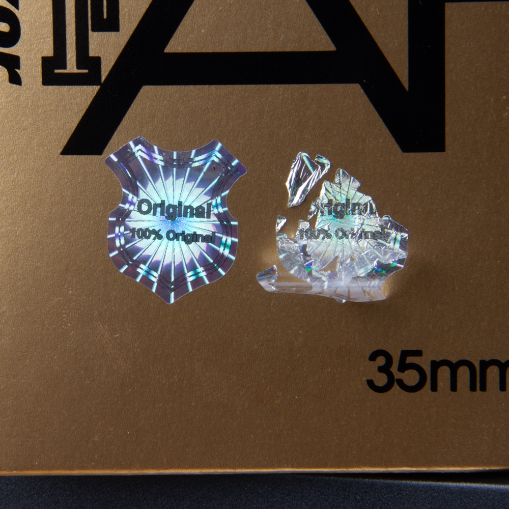 Original silver security sticker, 23 x 20 mm, Shield